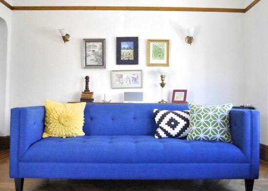bright blue couch with yellow and green pillows