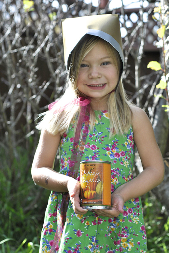 little girl holding pumpkin with Thanksgiving DIY hat