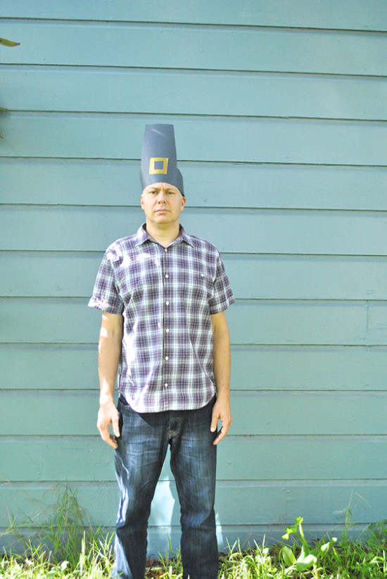 man wearing construction paper Thanksgiving hat