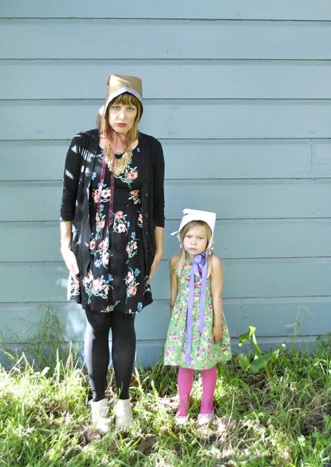 mom and daughter wearing Thanksgiving hats with serious faces