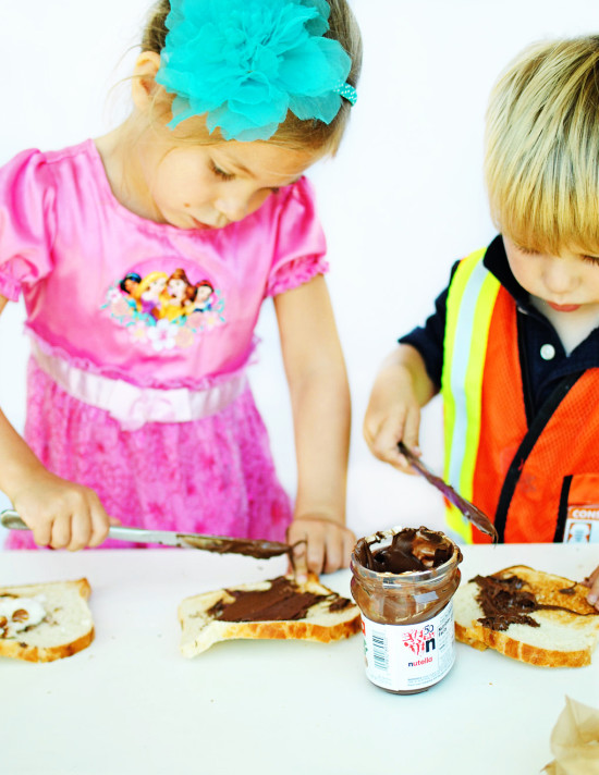kids spreading nutella for easy s'more sandwiches - Fabulistas