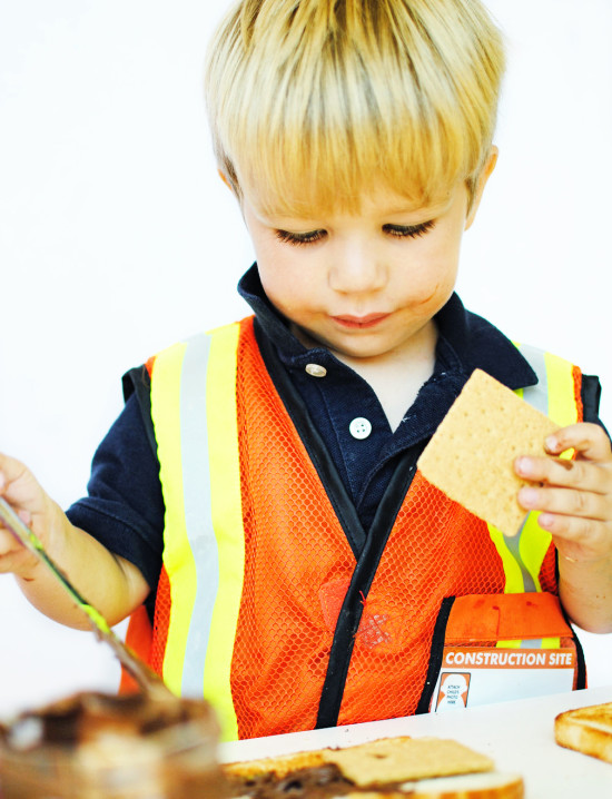 little boy adding graham crackers to s'more sandwich - Fabulistas