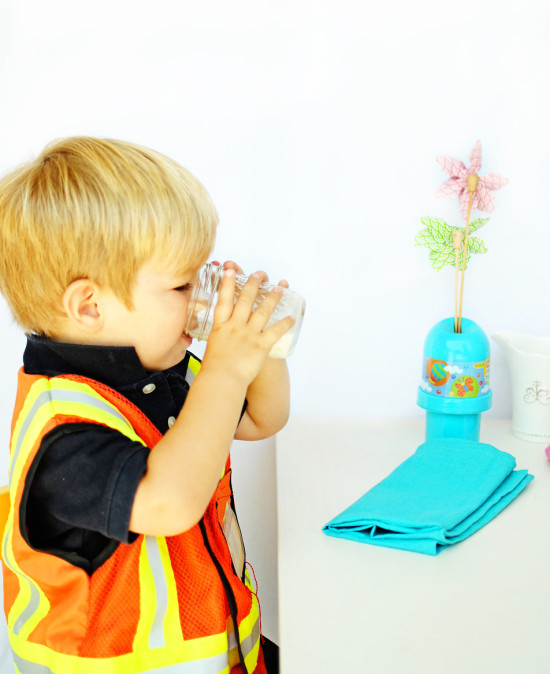 little boy drinking milk at pretend restaurant - Fabulistas