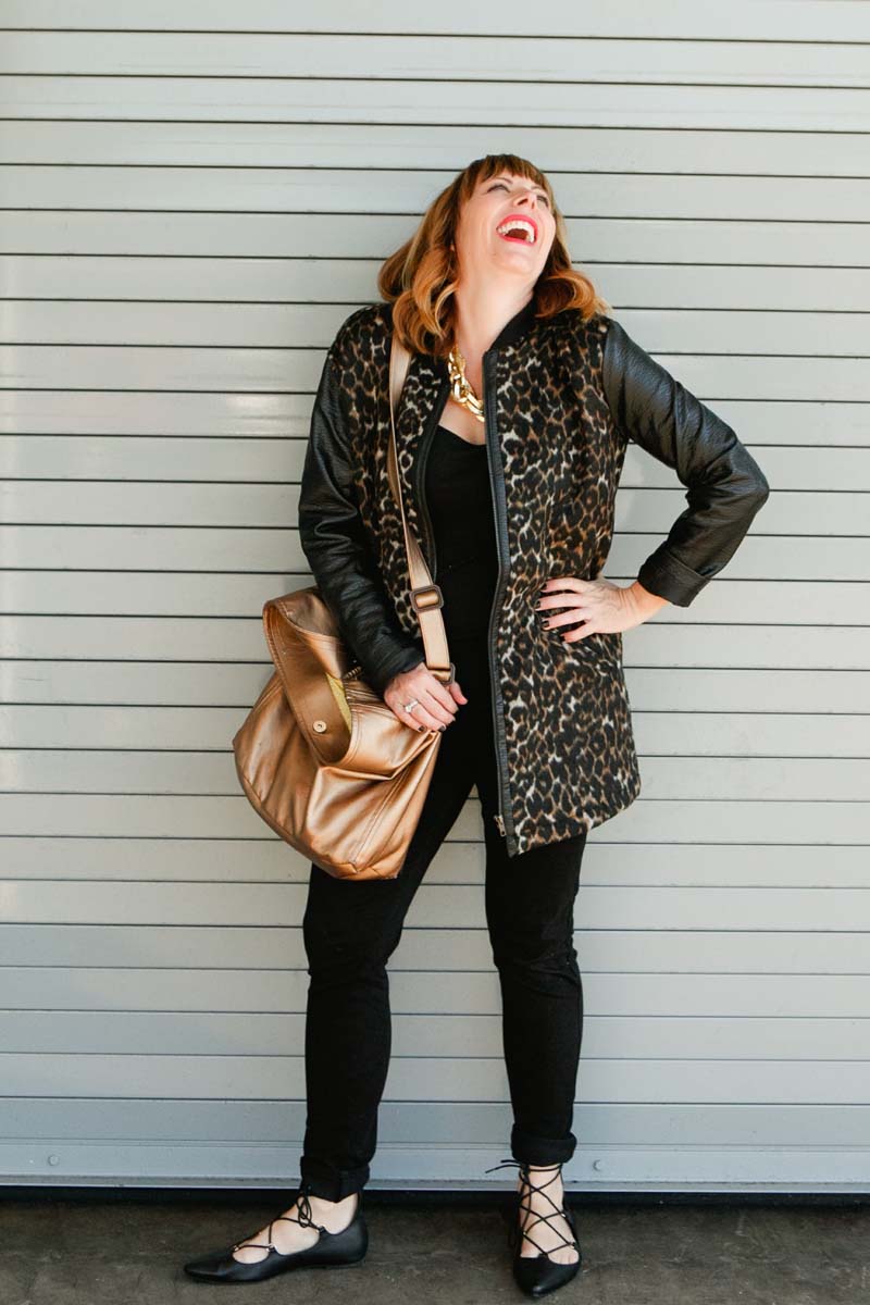 mom laughing in animal print coat with ballet flats - Fabulistas
