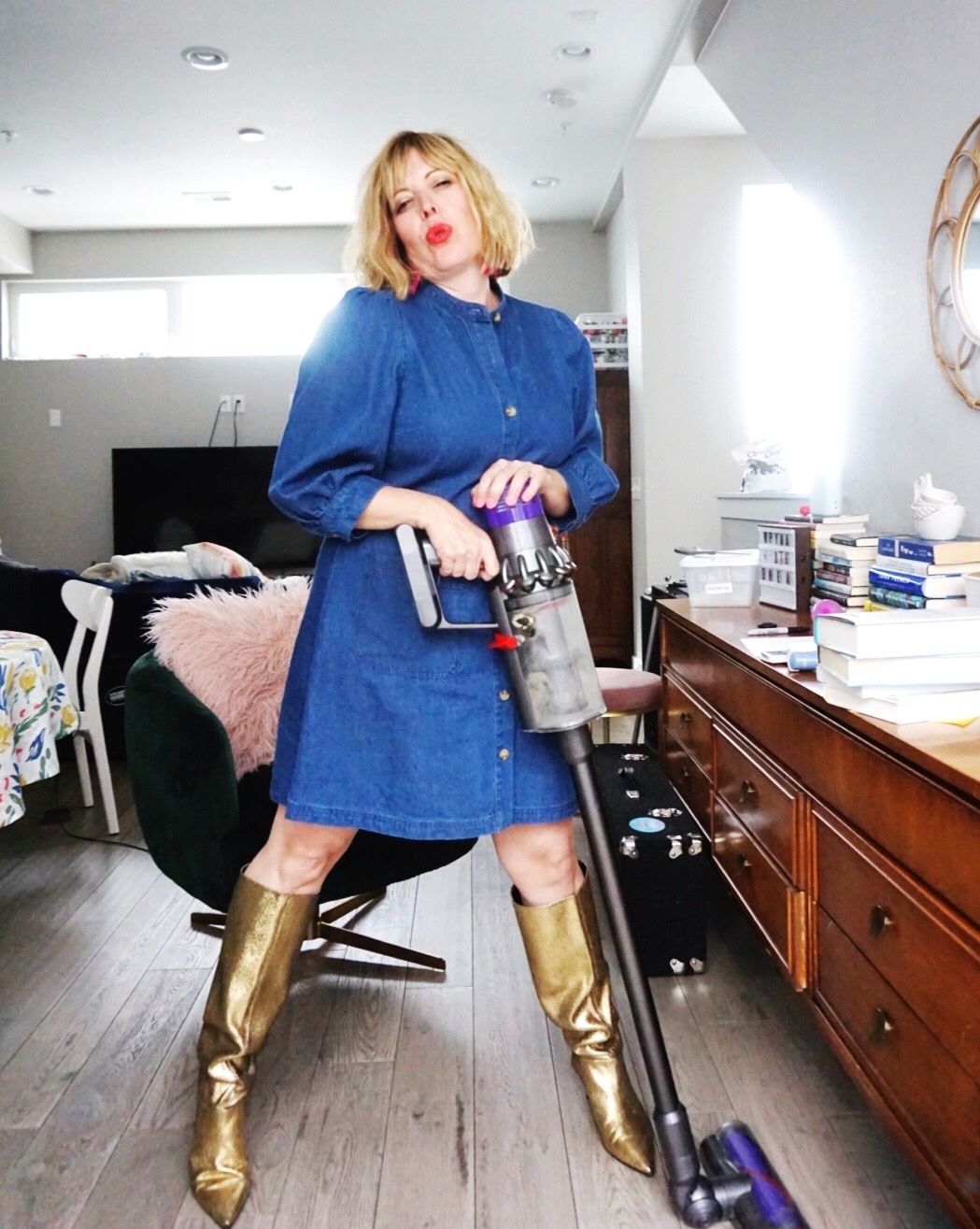 mom in gold boots with vacuum cleaner