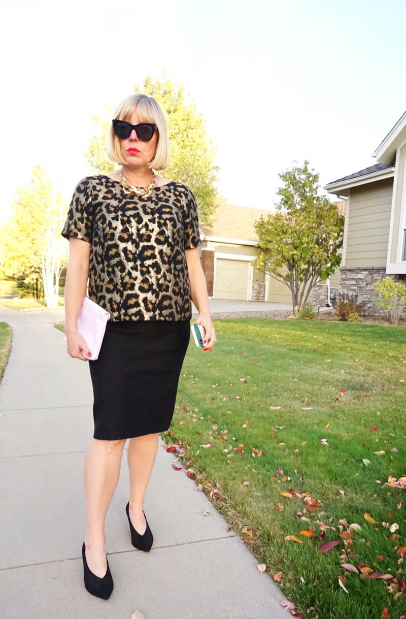 woman dressed as Anna Wintour stands on suburban street