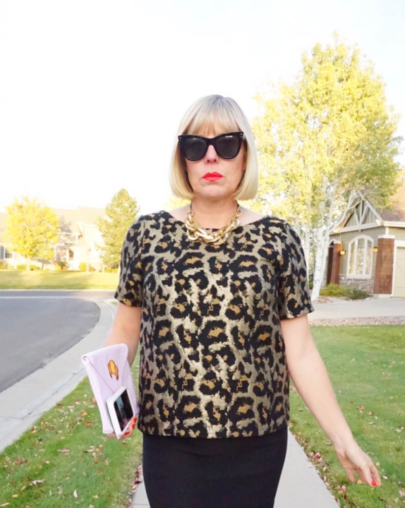 woman dressed in Anna Wintour Halloween costume looks at camera